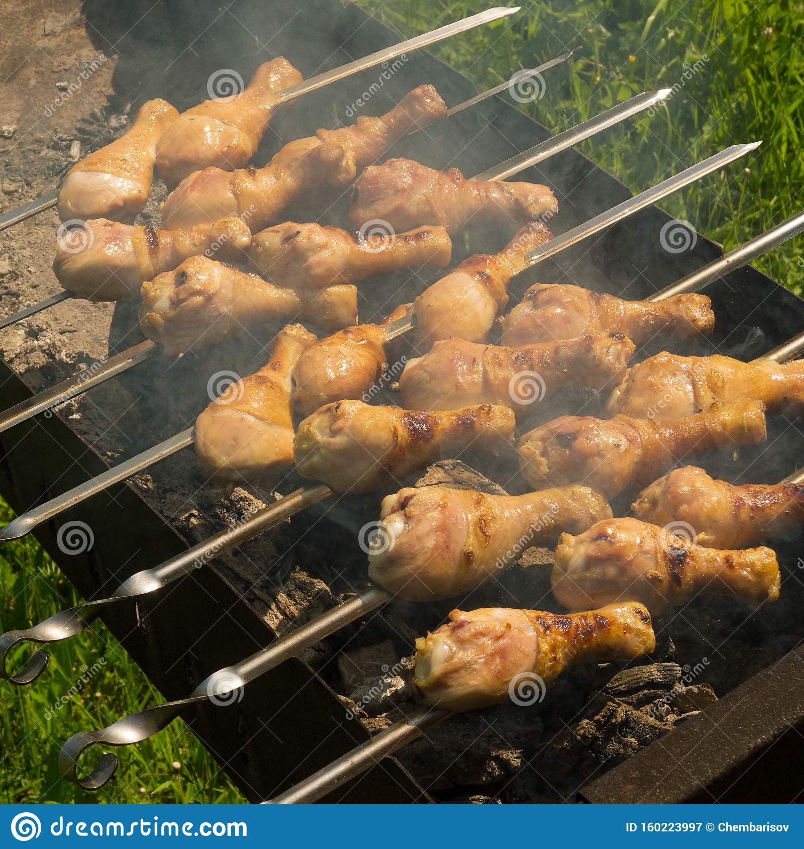 Cooking Fresh Juicy Chicken Legs on the Grill Stock Image