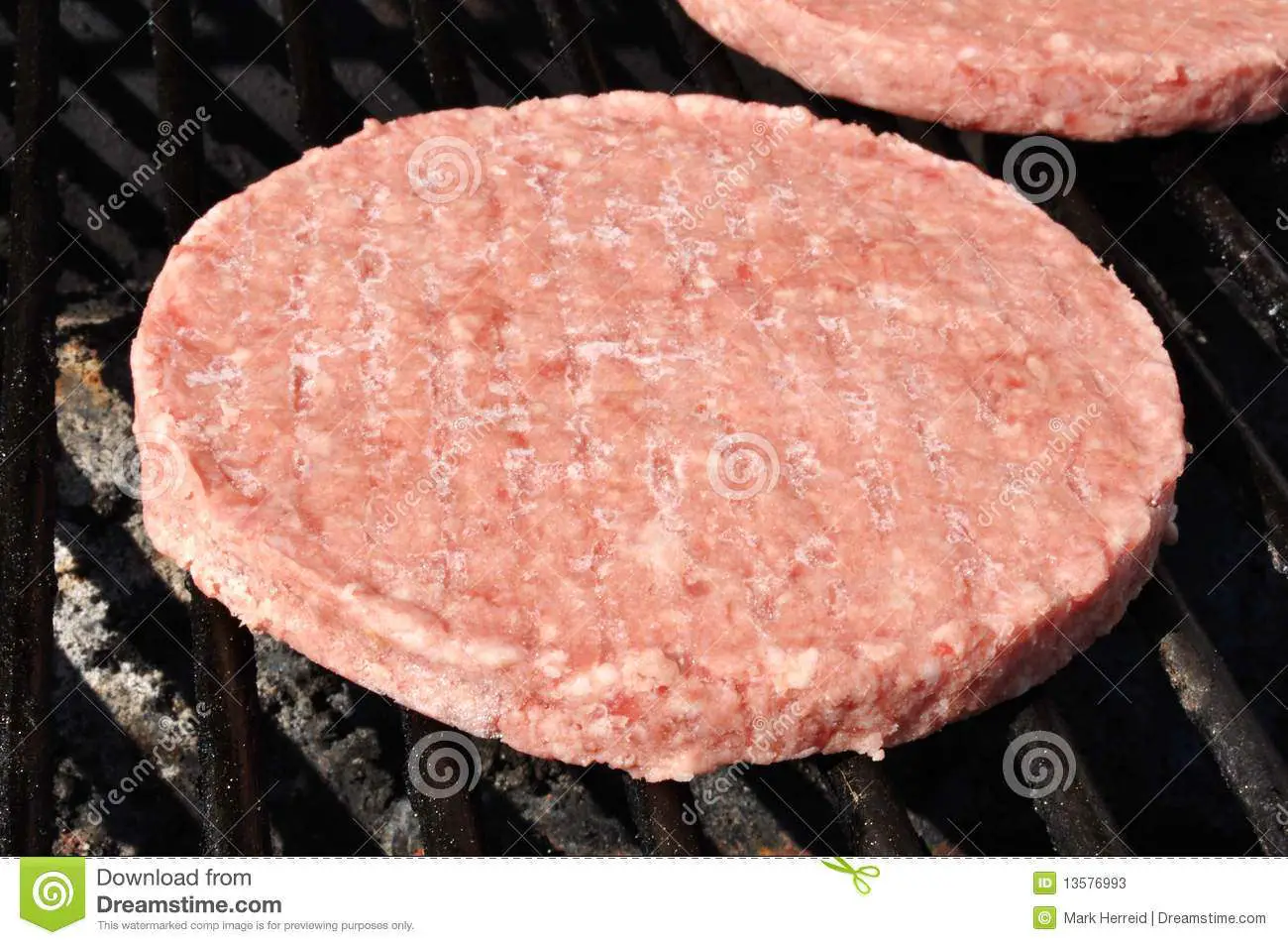 Frozen Hamburger Patties On The Grill Stock Image