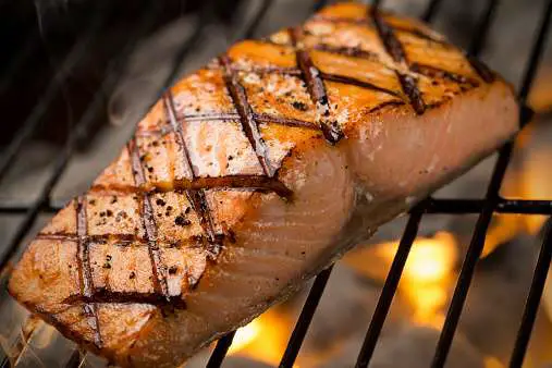 Grilled Salmon Filet Cooking On A Charcoal Grill Stock Photo