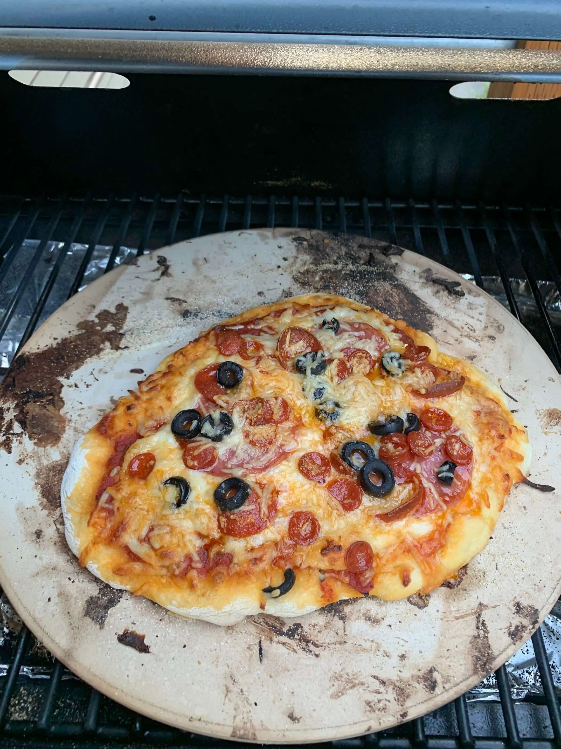Pizza on a stone in a Traeger grill